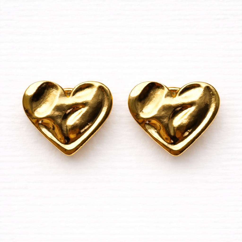 Coco Plutee gold heart button pair on white background.